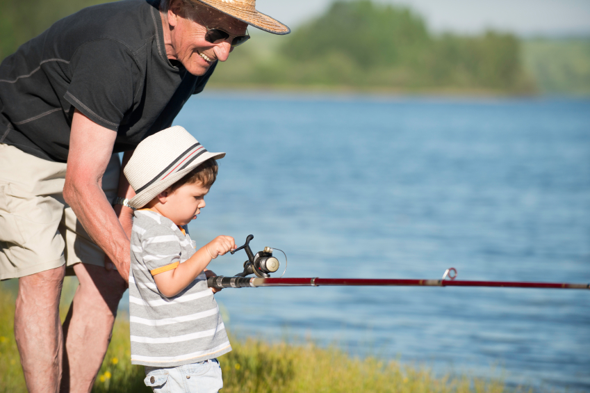 Active senior fishing with grandson